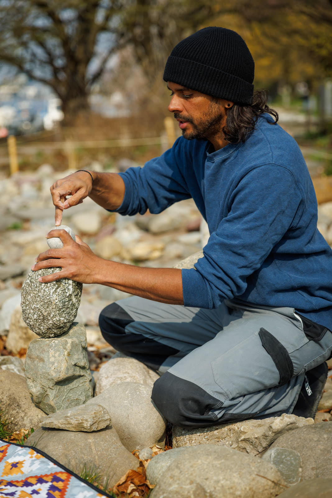 Greg setting a stone into balance with a single fingertip